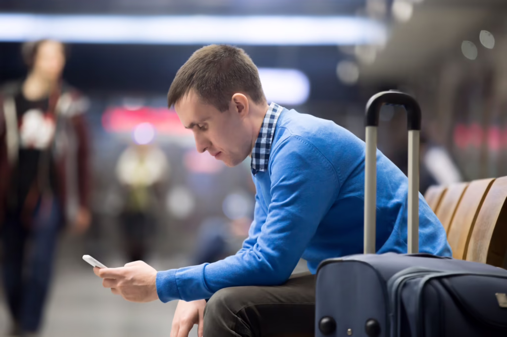 A visa applicant waits at an airport after being required to leave the United States to complete green card processing at a U.S. consulate abroad.