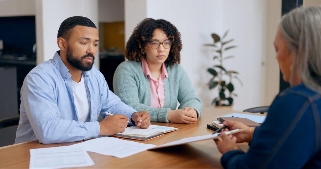 Couple meeting with an immigration lawyer finding out how to pay an immigration bond.